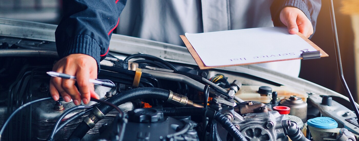 Engine inspection being performed by mechanic.