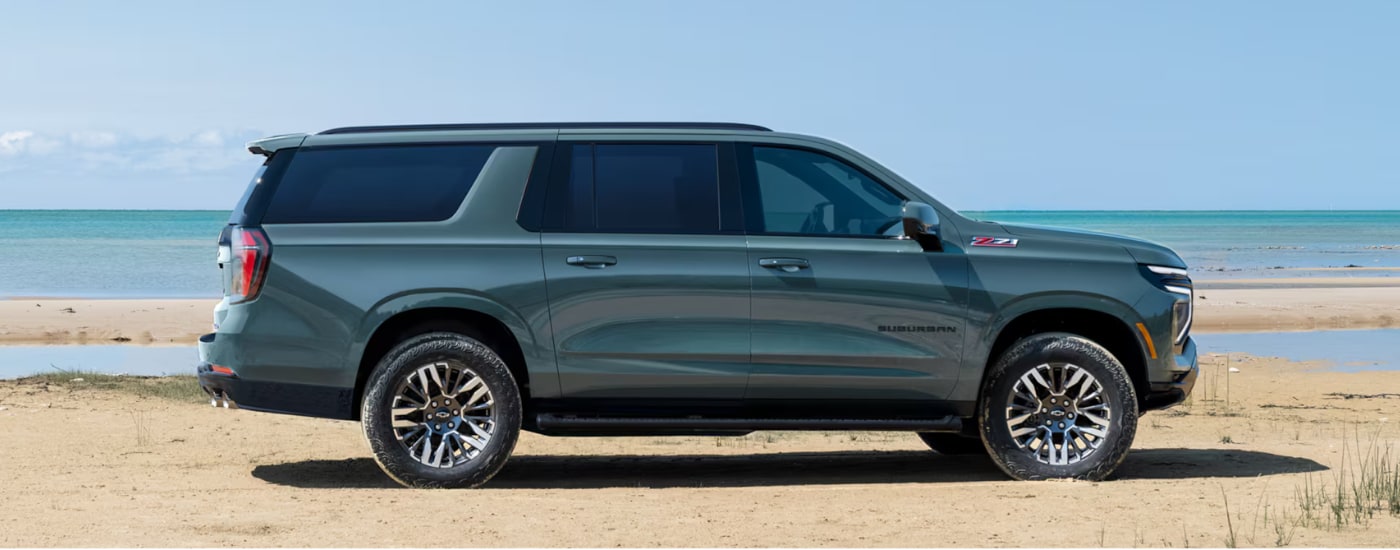 2026%20Chevy%20Suburban%20-%20beach.png Blue 2026 Chevy Suburban driving along a beach