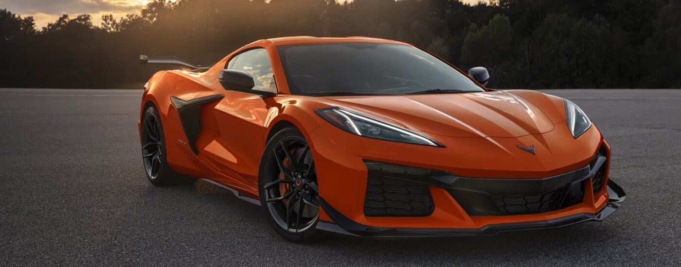 2026%20Chevy%20Corvette%20Z06%20-%20dusk.png Orange 2026 Chevy Corvette Z06 parked at an angle at dusk