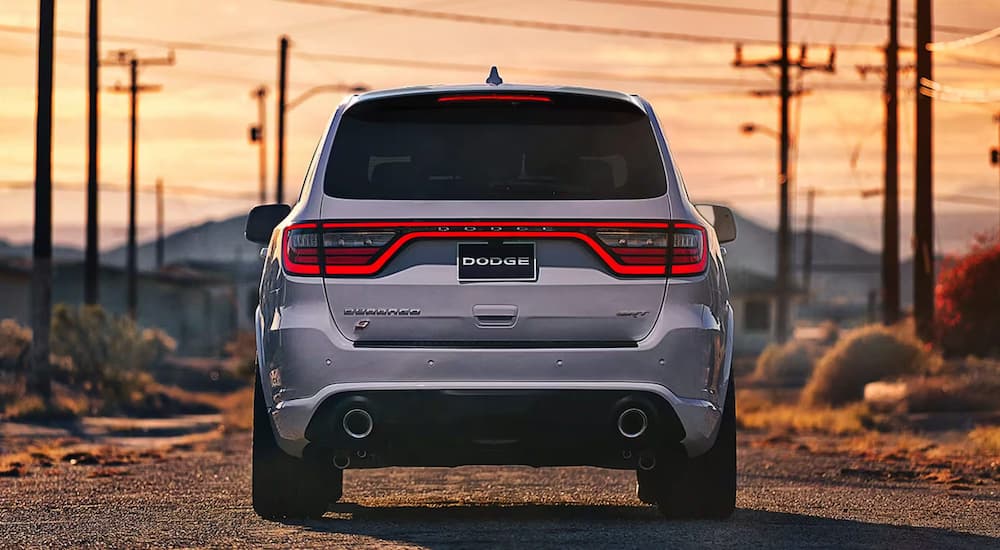 A rear view of a white 2024 Dodge Durango SRT parked on a dirt road.