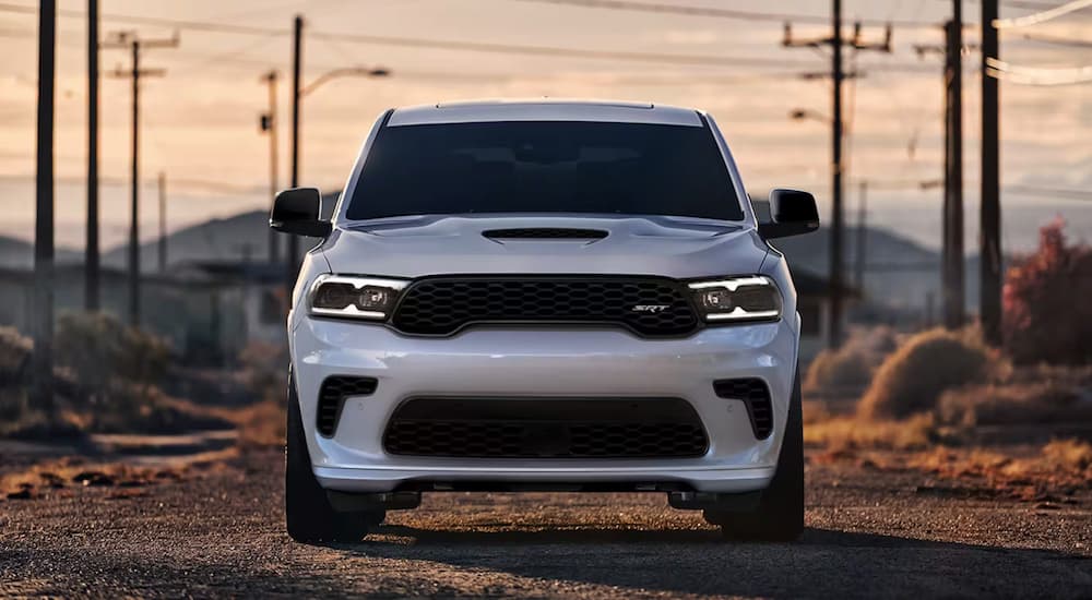 A white 2024 Dodge Durango SRT is parked on a dirt road after leaving a Dodge dealer near Lancaster.