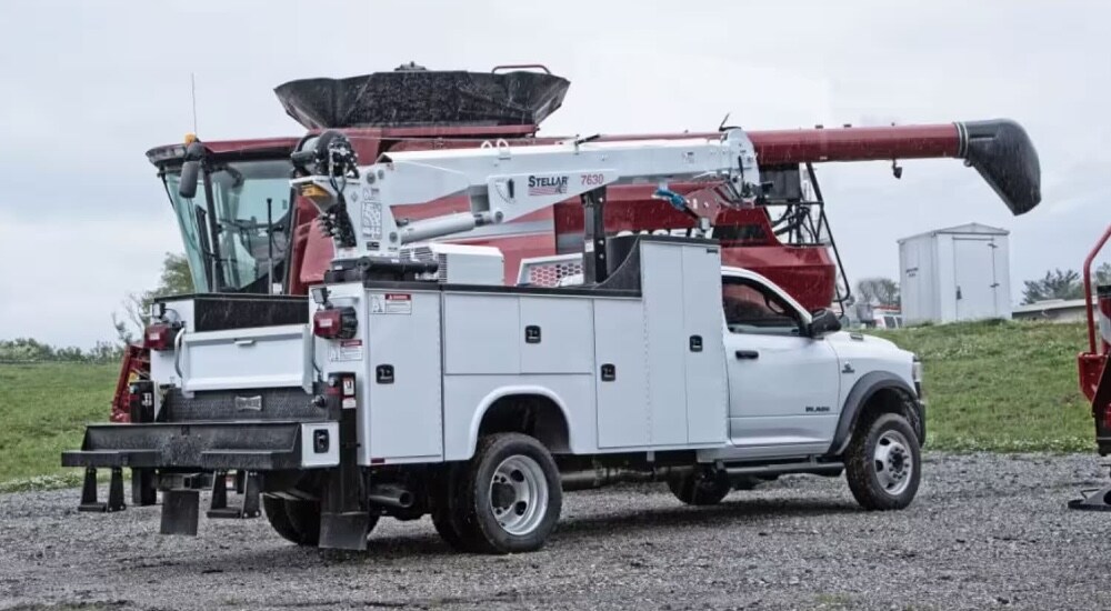 A white 2024 Ram 5500 Chassis is parked on a gravel.