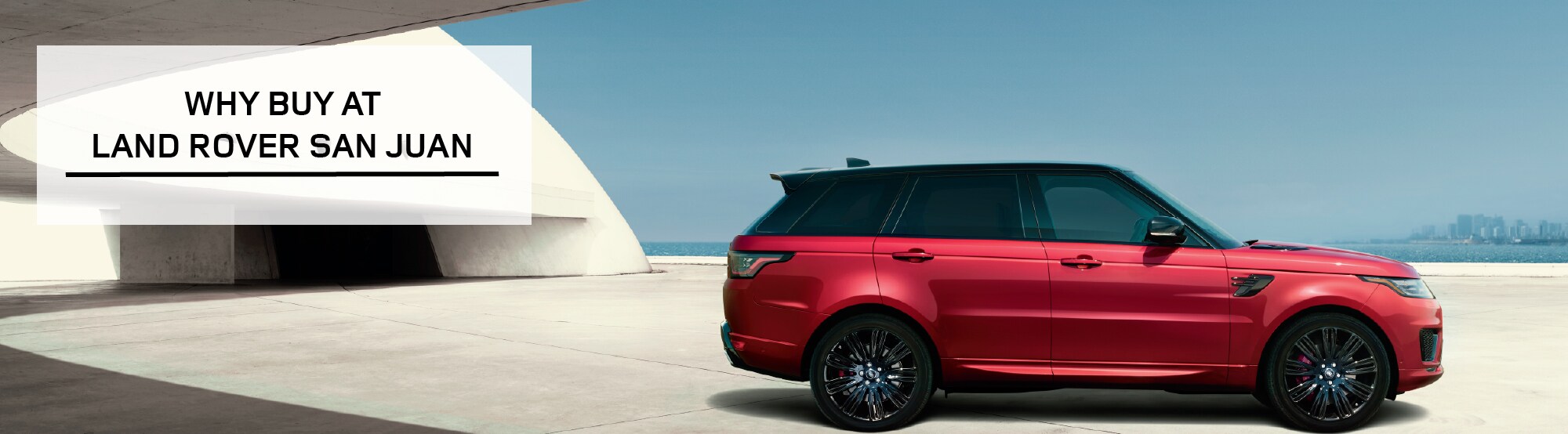 WHY BUY AT LAND ROVER SAN JUAN. RED RANGE ROVER PARKED BY OCEAN.