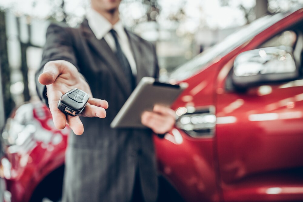 Buyer Getting Keys to New Red Car.jpg