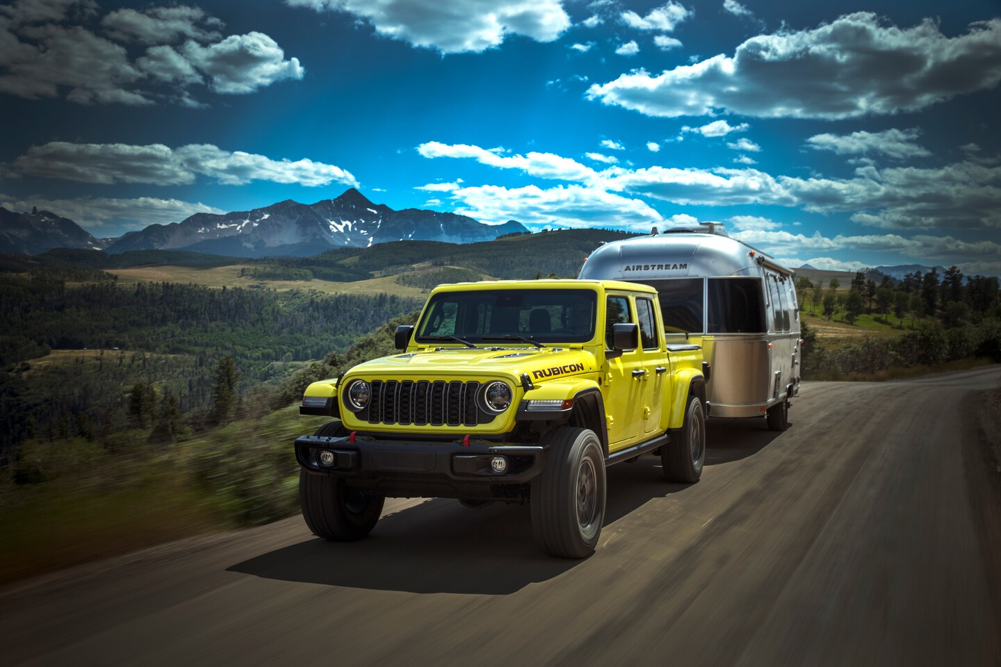 2025 Jeep Gladiator Rubicon towing a camper