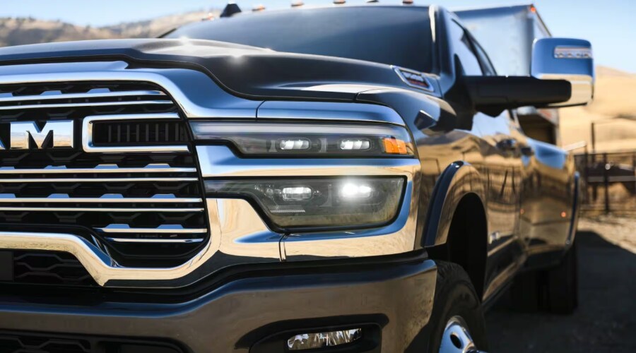 Front grill of a RAM 3500 dually truck in Ramsey showing heavy duty rear wheels and towing mirrors.