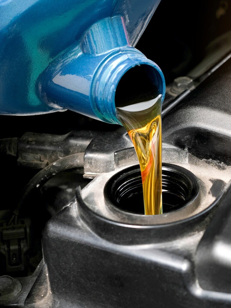 refueling-and-pouring-oil-quality-into-the-engine-motor-car-and-picture-id1083543944.jpg