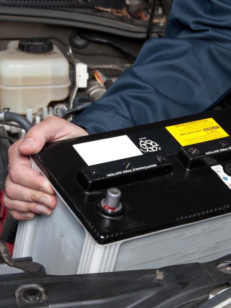 auto-mechanic-replacing-car-battery-picture-id106545560.jpg