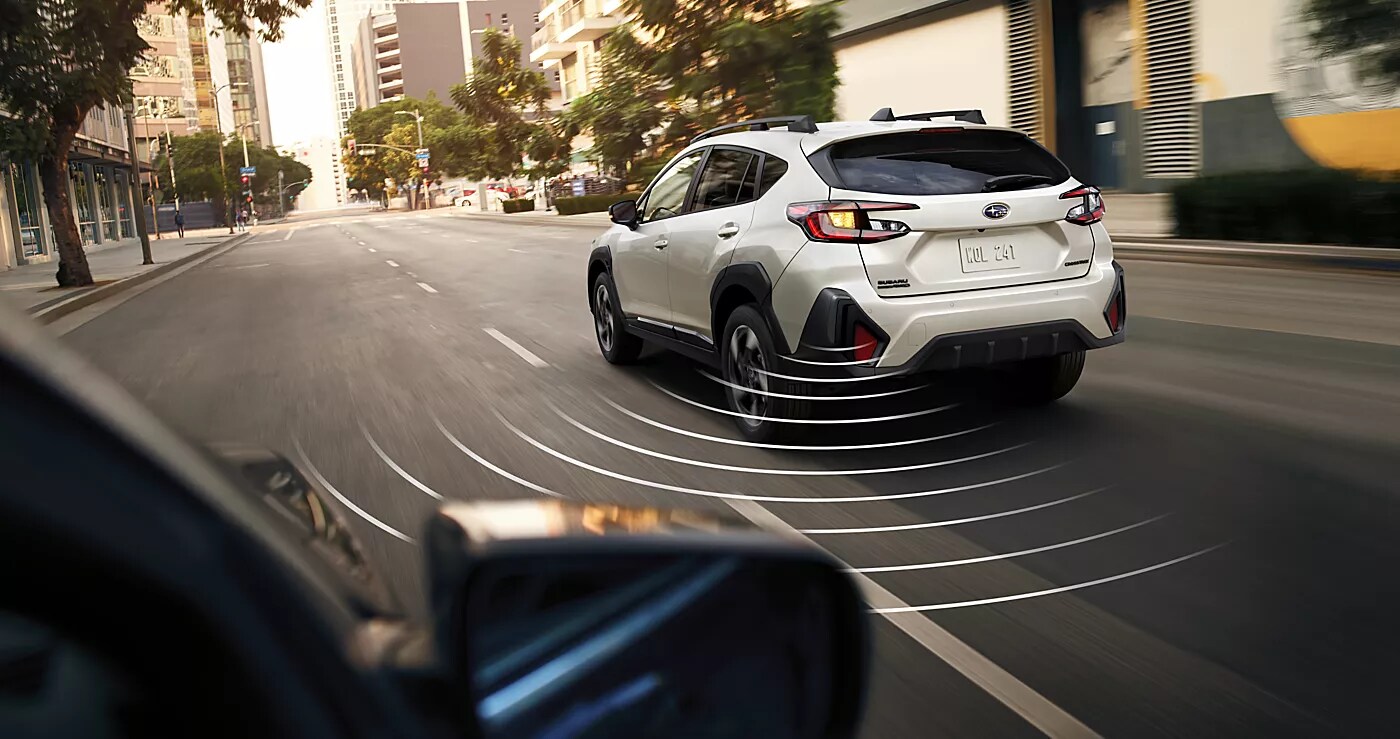 2027 Subaru Crosstrek driving on off-road terrain.