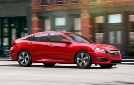 16_Civic_Sedan_Touring_Location_CityDriving_RalleyeRed.jpg