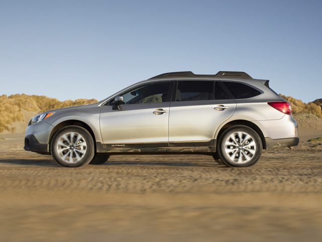 2017 Subaru Outback SUV silver facing left on sand with dunes in background.jpg