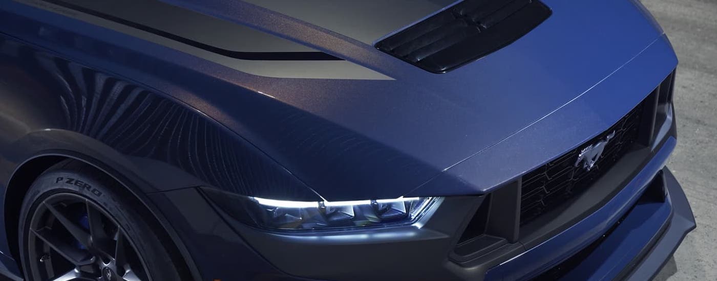 Ford%20Dealer%20Near%20Me%20-%202024%20Ford%20Mustang%20Dark%20Horse%20-%20Dark%20Blue%20Front%20(1).jpg A close up of the front half of a dark blue 2024 Ford Mustang Dark Horse at a Ford dealer near you.