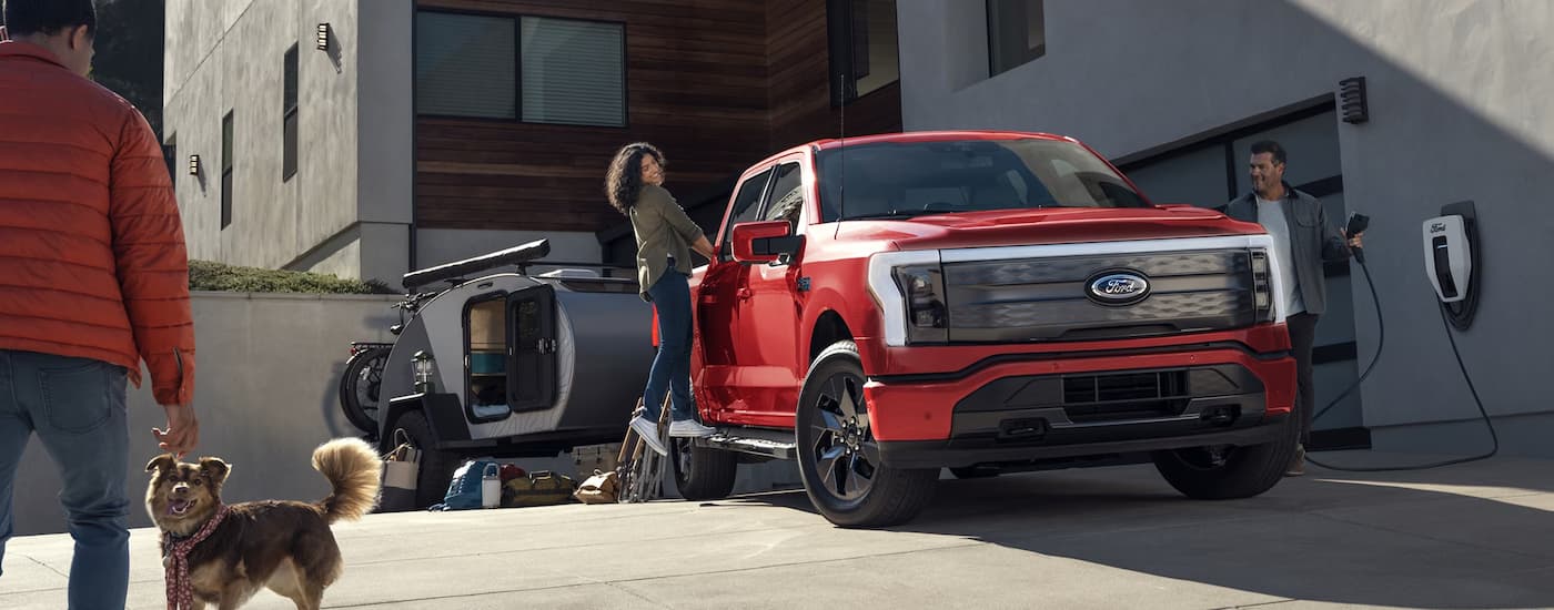 Trucks for Sale Near Nevada 2024 Ford F-150 Lightning - Red Driveway (2).jpg Red 2025 Ford Lightning parked in a driveway
