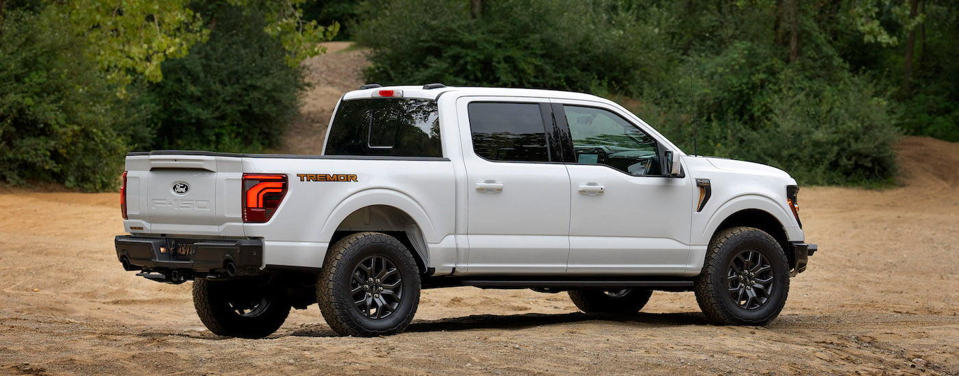 A white 2025 Ford F-150 Tremor from the side after leaving a dealer that has Ford trucks for sale.