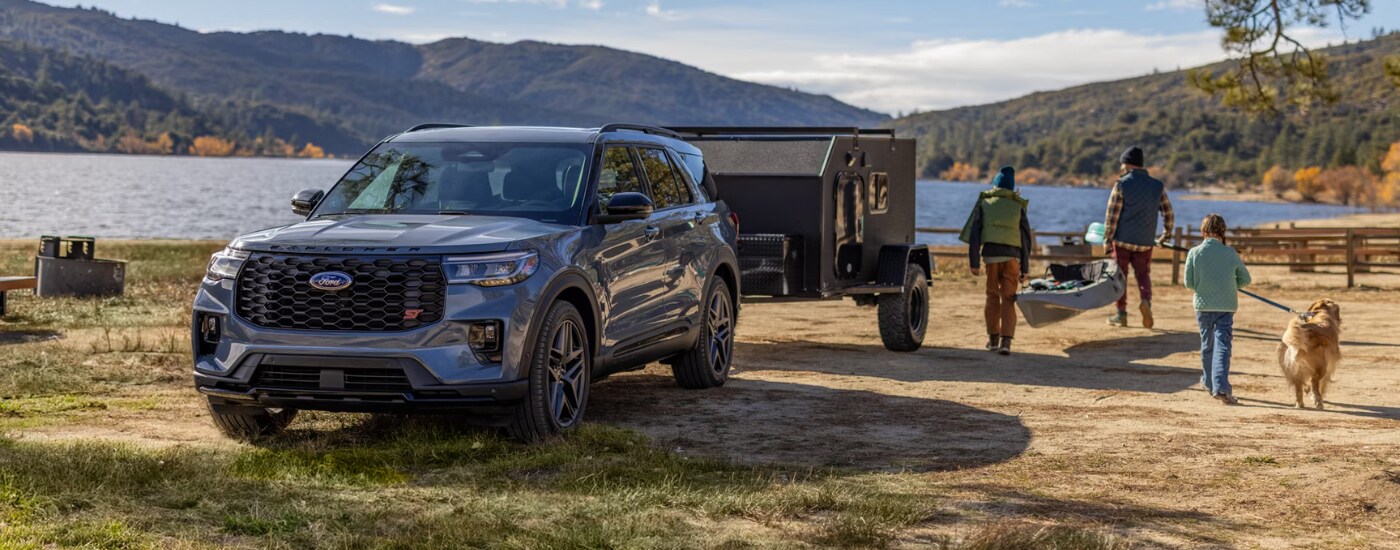 2026 Ford Explorer - capability.png A family unloading kayaks from their black 2026 Ford Explorer