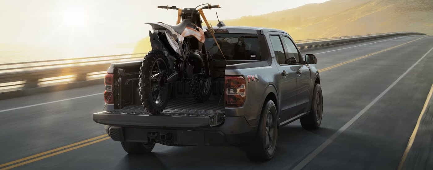 Trucks%20for%20Sale%20Near%20Toledo%202025%20Ford%20Maverick%20FX4%20-%20Dirtbike.jpg Grey 2025 Ford Maverick with a dirtbike in the bed