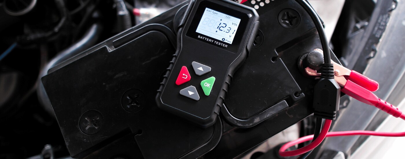 Mobile%20Mechanic%20Battery.png Mechanic testing car battery voltage