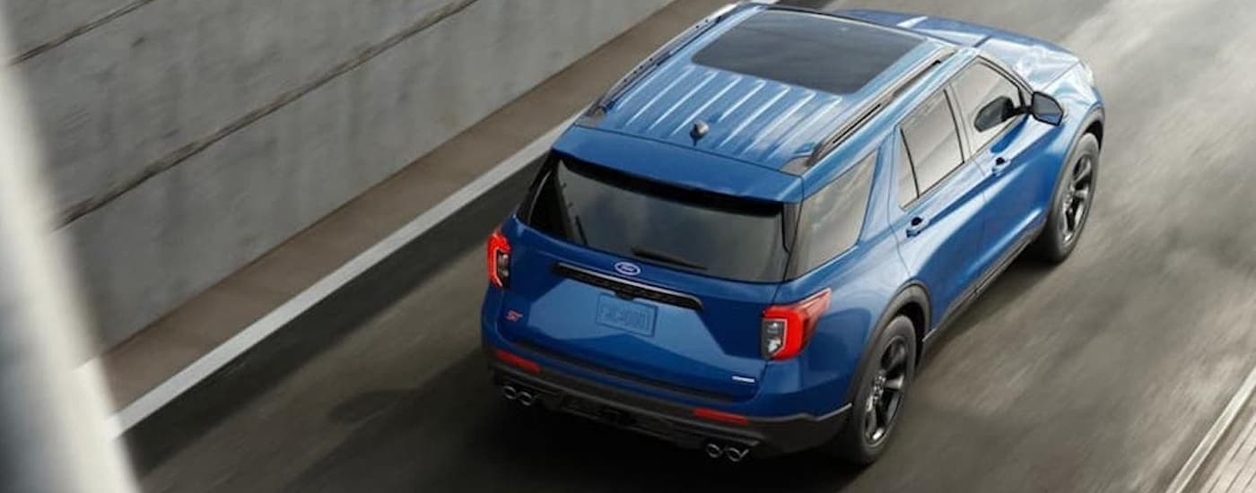 Ford%20Dealer%20Near%20Me%20-%202020%20Ford%20Explorer%20ST%20-%20Blue.jpg A blue 2020 Ford Explorer ST driving up a highway ramp in a city.