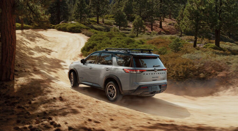 Overhead view of a silver 2025 Nissan Pathfinder Rock Creek driving on a dusty trail.