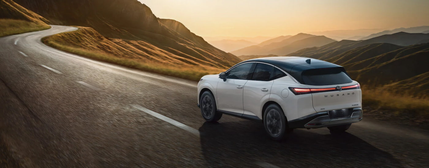 Nissan%20Murano%20for%20Sale%20Near%20Troy%20-%202026%20Nissan%20Murano%20-%20White%202.jpg Rear of a white 2026 Nissan Murano driving down a road.