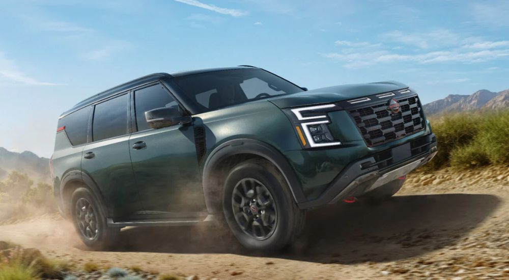 A green 2025 Nissan Armada PRO-4X off-roading.