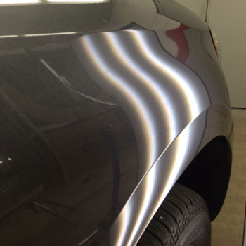 Small dent near wheel arch after repair at Reliable Collision Center in Springfield Missiouri