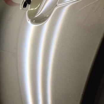 Small dent near wheel arch after repair at Reliable Collision Center in Springfield Missiouri