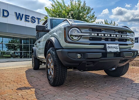 Bronco by woods and lake