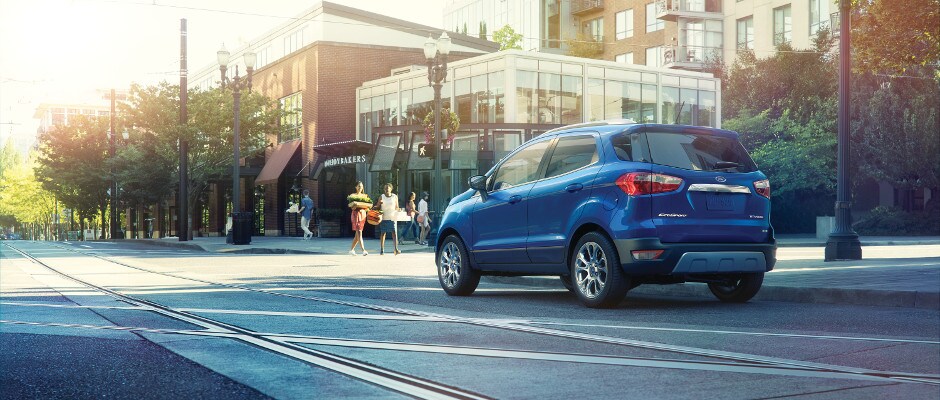 Schedule a Test Drive Today A blue Ford EcoSport at a stop light