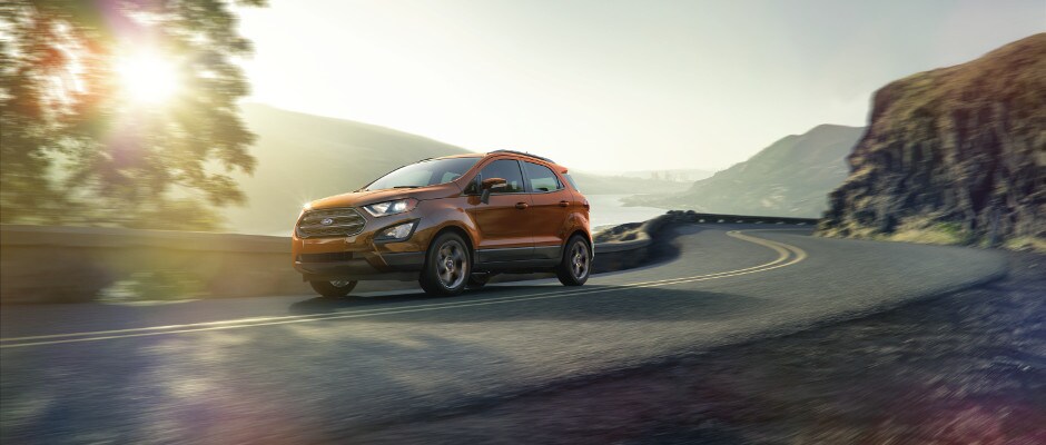 Exterior Design An orange Ford EcoSport driving down a curved road
