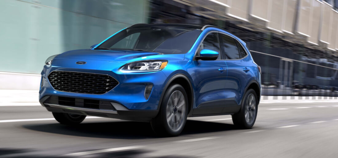 2020 Ford Escape in blue driving down a city road