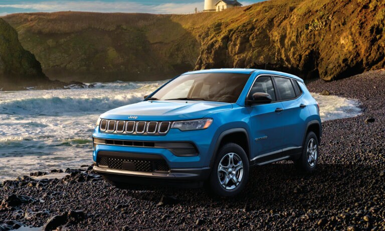 2025 Jeep Compass parked on a rocky beach