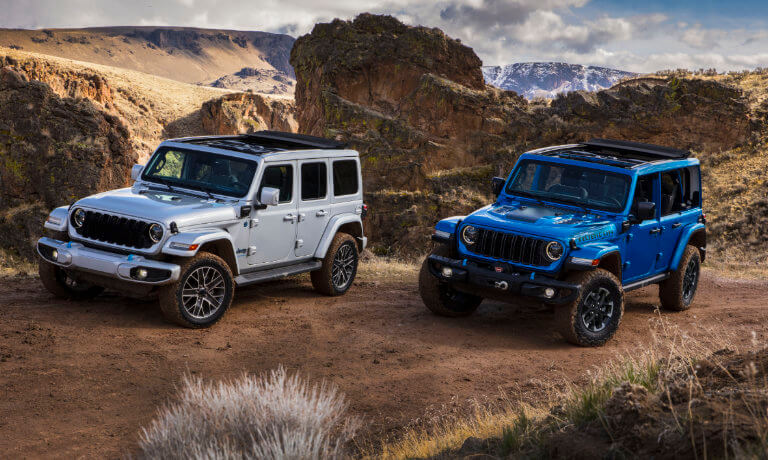 Two 2024 Jeep Wrangler 4xes parked side by side in desert