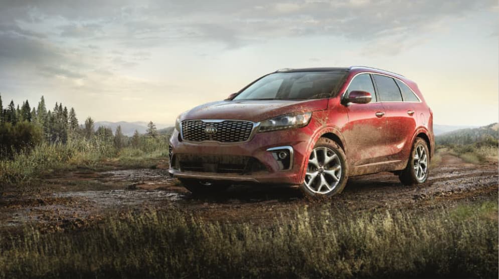 A red 2020 Sorento SX covered in mud