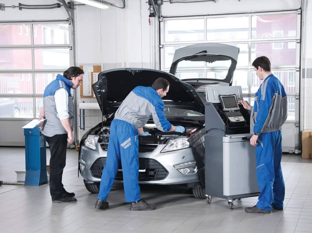 mechanics working on a car