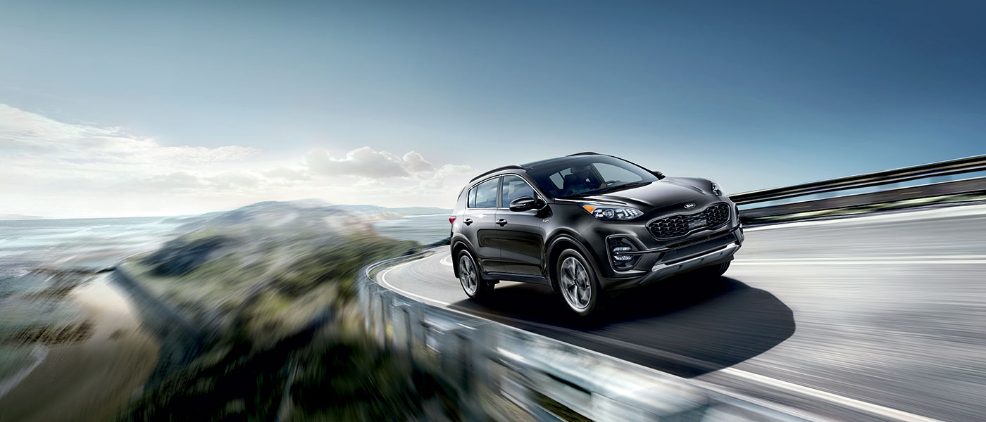 Grey 2020 Kia Sportage driving on highway