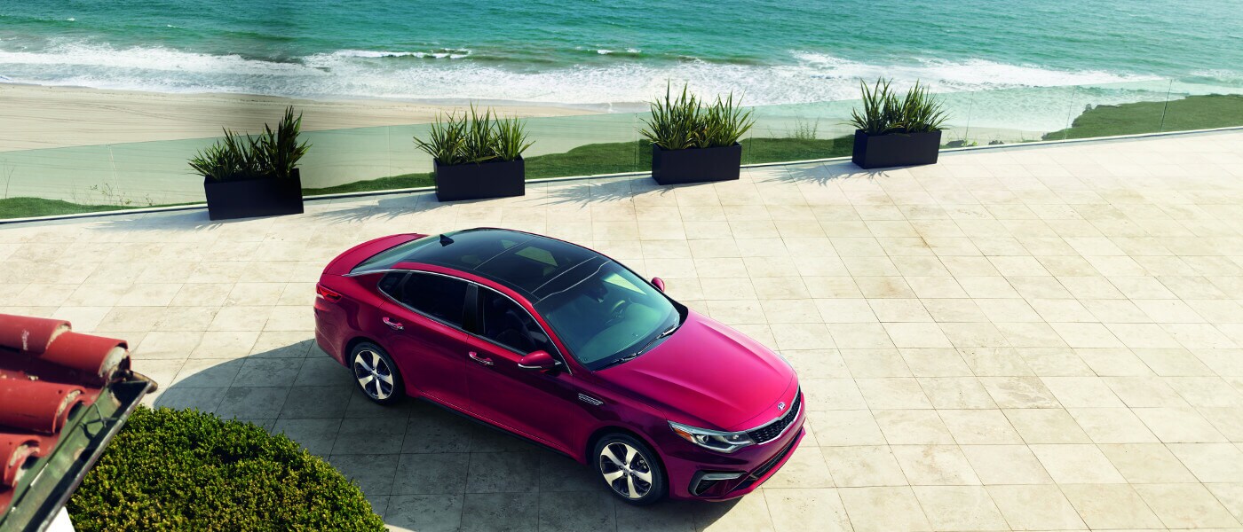 Red 2019 Kia Optima near beach