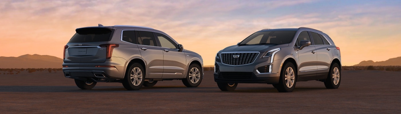 Two XT5 parked overlooking hills new CADILLAC XT5 SUV