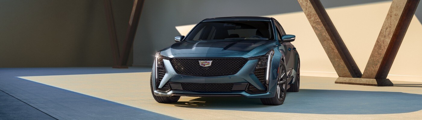 Dark Blue CADILLAC CT5 parked in front of V shaped support beams 2025 CADILLAC CT5 Sedan