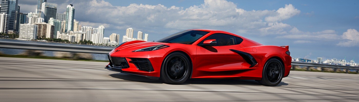 2025 Chevy Corvette Stingray 2025 Chevrolet Corvette Stingray speeding down a highway overlooking a city skyline