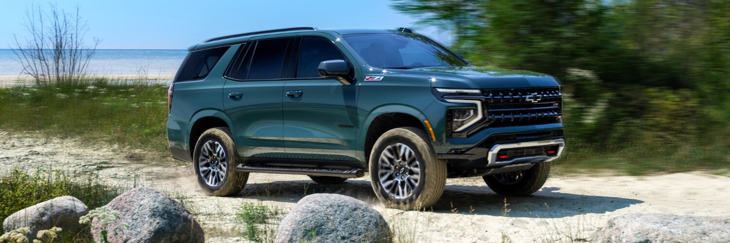 2025 Chevy Tahoe 2025 Chevrolet Tahoe Z71 SUV driving away from the beach on a sandy road