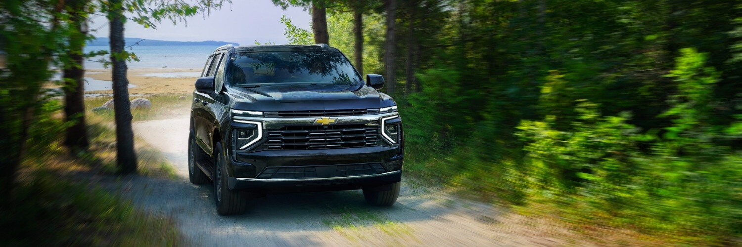 2025 Chevy Tahoe Chevy Tahoe driving on a narrow gravel road