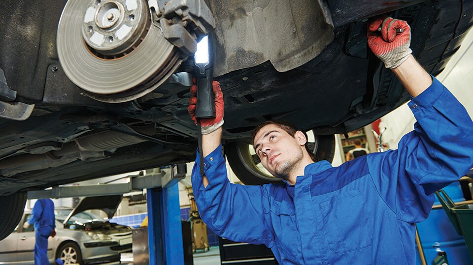 A mechanic changing the brakes on a car