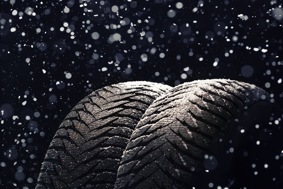 winter tires with falling snow.jpeg