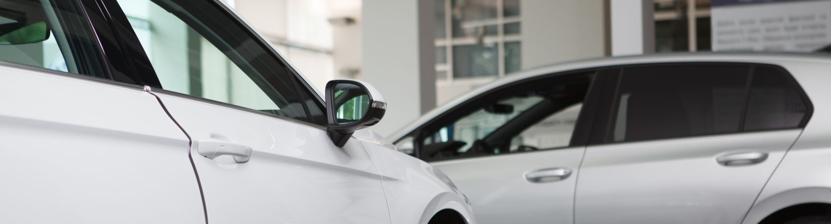 Vehicle Reviews Closeup of a white Nissan