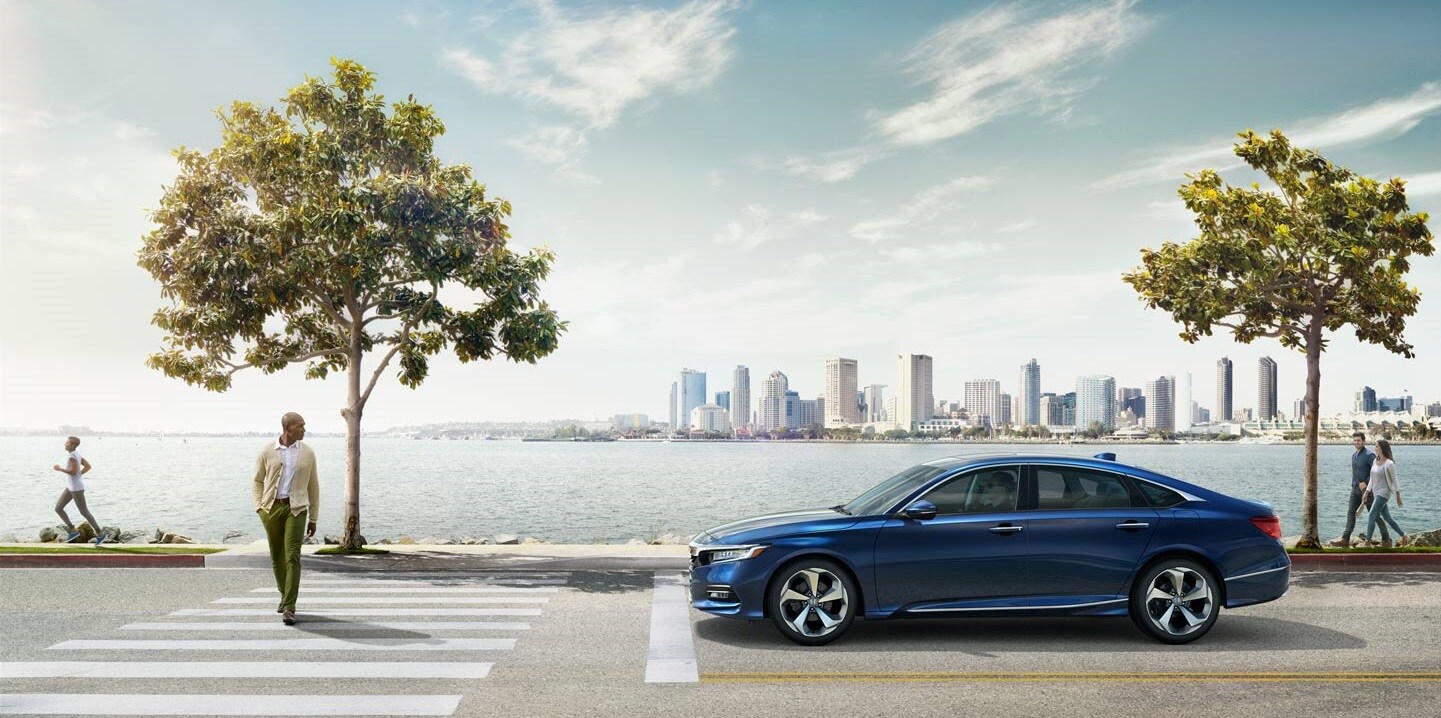 2019-Honda-Accord-Touring-Sedan-L01.jpg 2019 Honda Accord at a crosswalk with a city landscape background