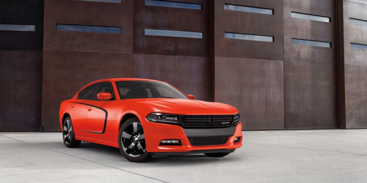 2020 Dodge Charger RT Sedan- oragne parked in front of metal wall with slats showing sky_hori.jpeg