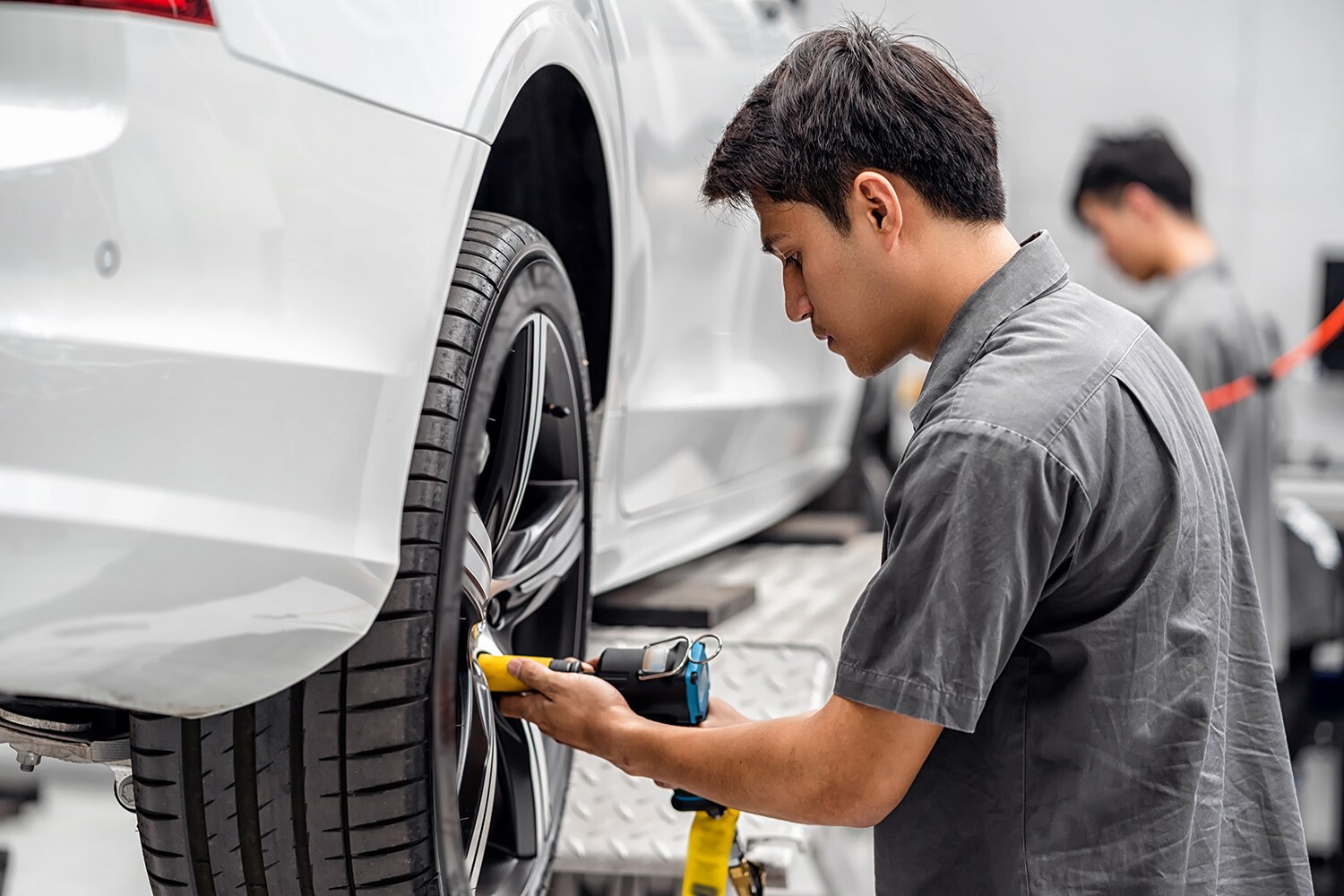 How to check your tires' health at Sale Auto Mall of North Kinston | Mechanic taking off wheel to replace tire