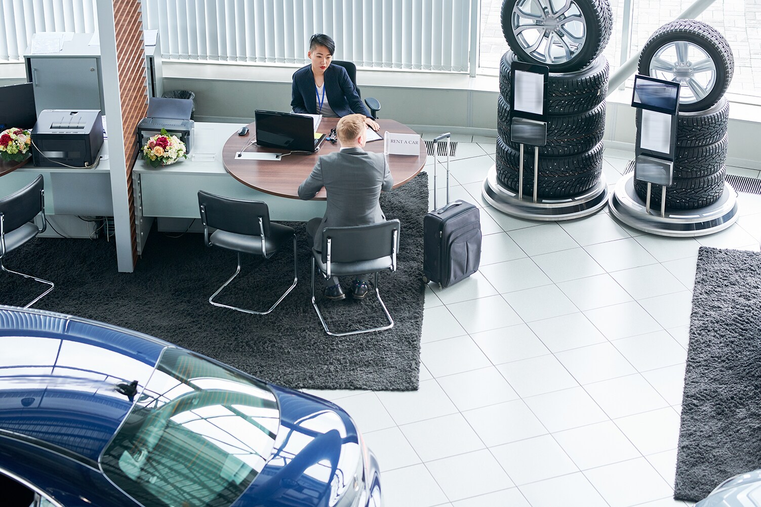 Documents to bring when purchasing a car at Sale Auto Mall in New Kinston | Customer being helped by sales associate at dealership desk