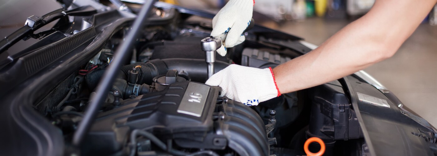 mechanic working on car engine